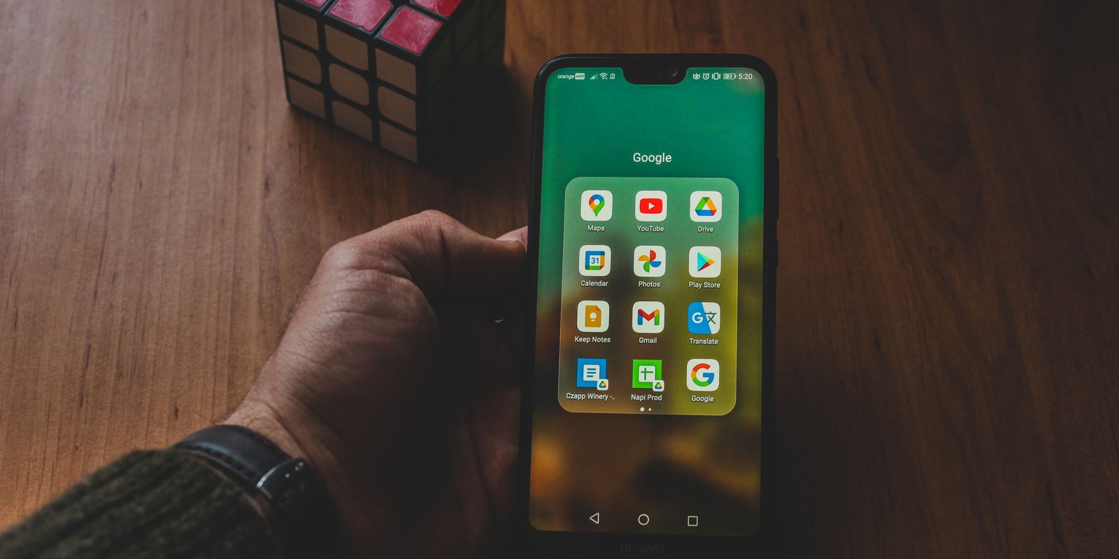 Phone-in-hand-on-desk-unlocked